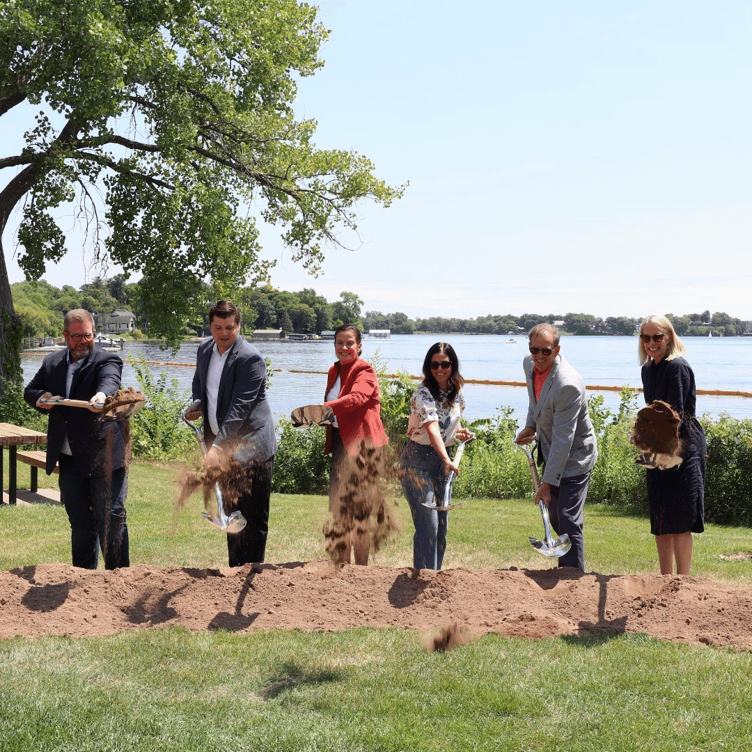 Community members at a lakeside groundbreaking in Wayzata