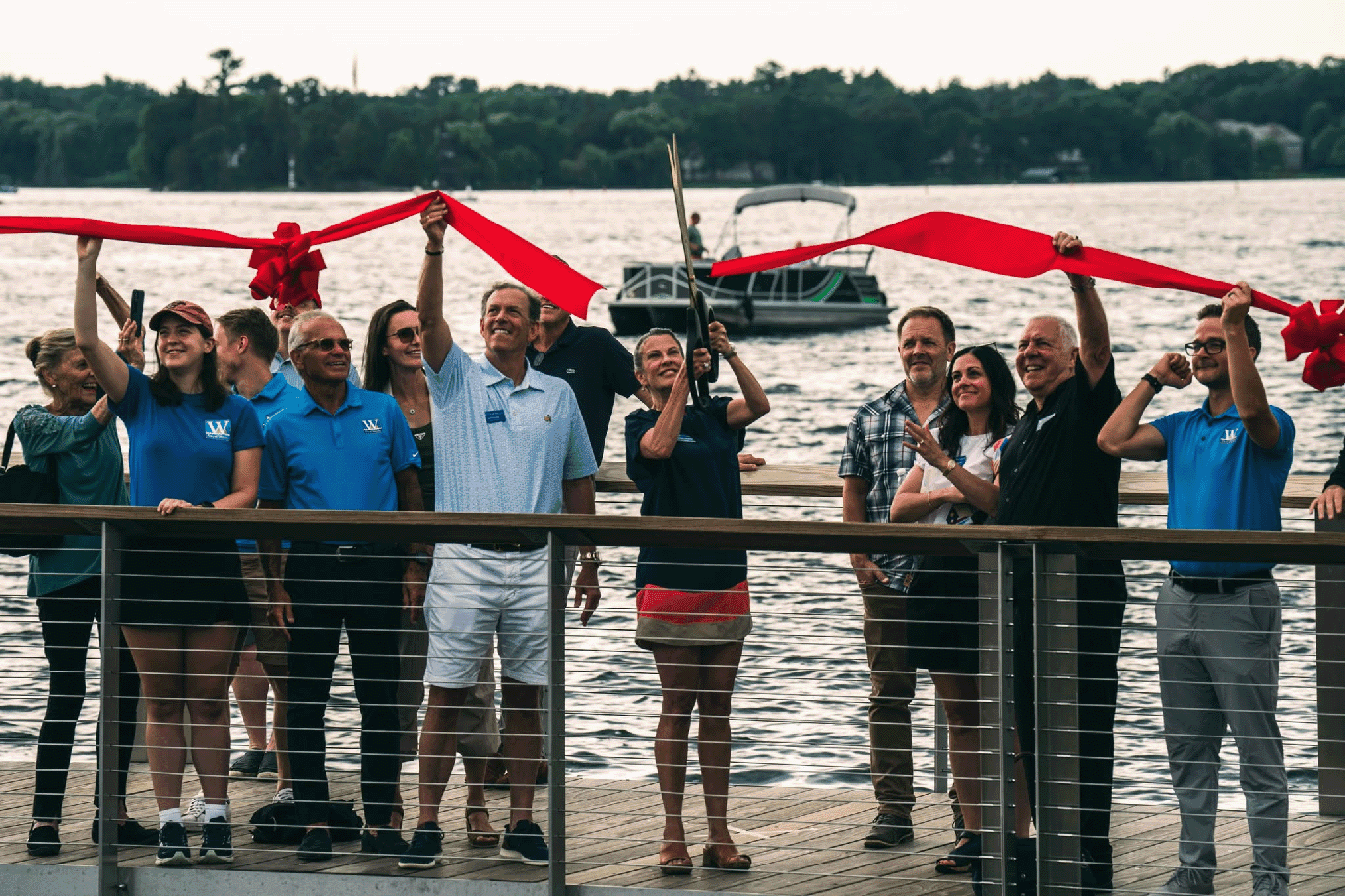 Community members celebrating a ribbon-cutting on the Wayzata boardwalk